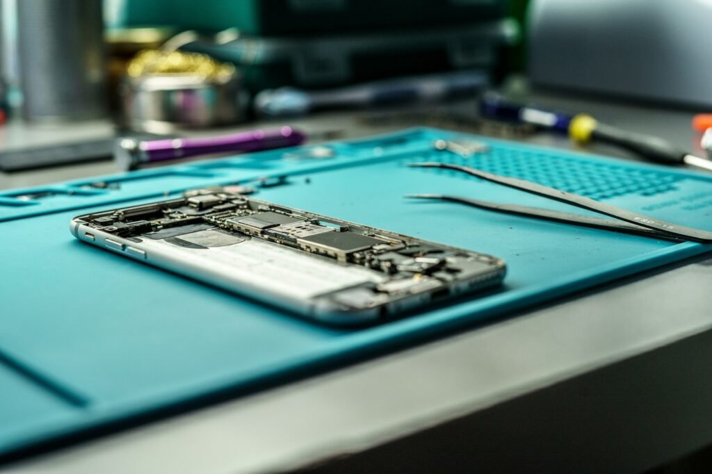 Closeup shot of a person repair a mobile in mobile repair smartphone workshop